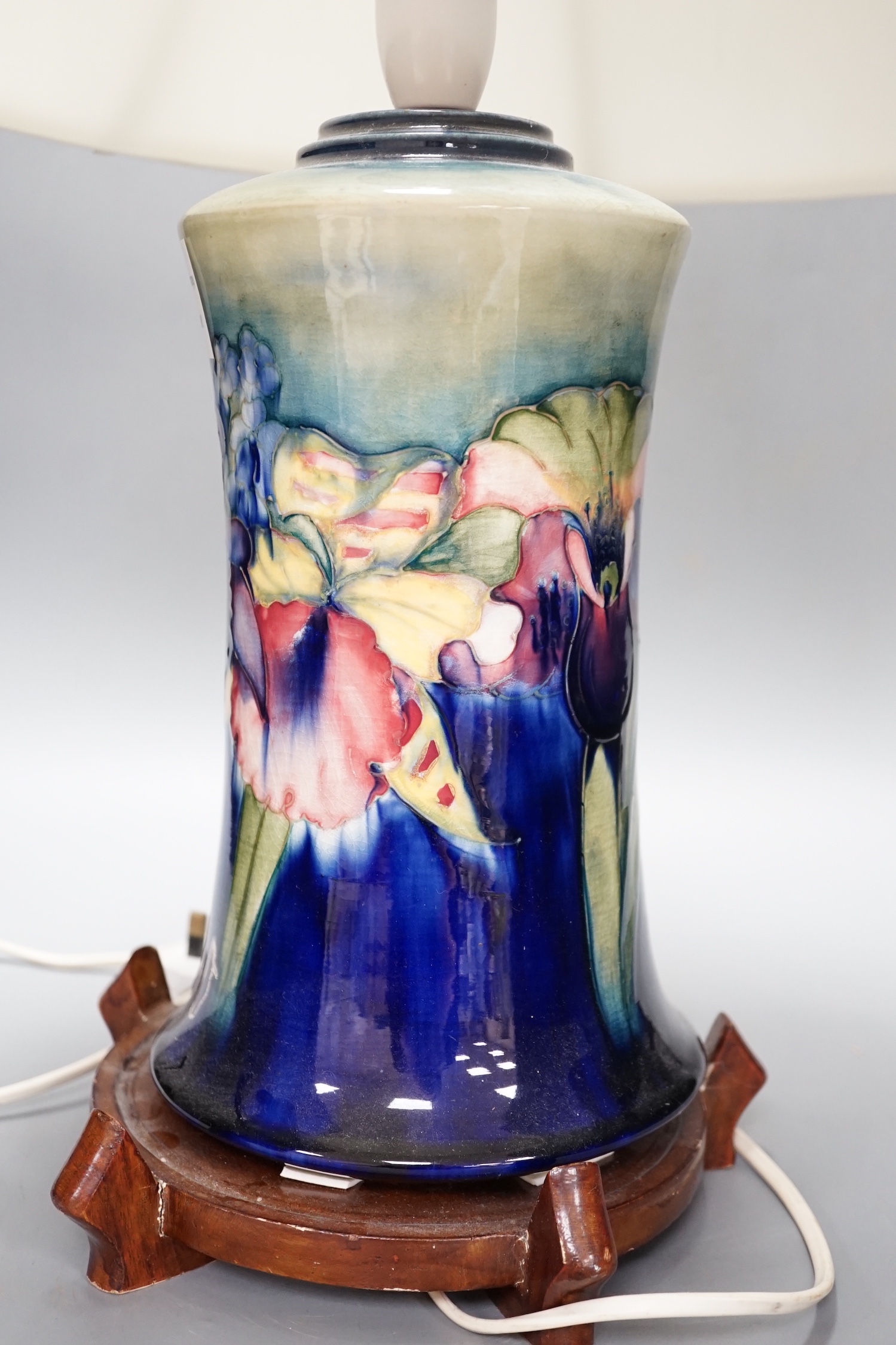 A Moorcroft orchid pattern lamp base with shade and later stand 30cm